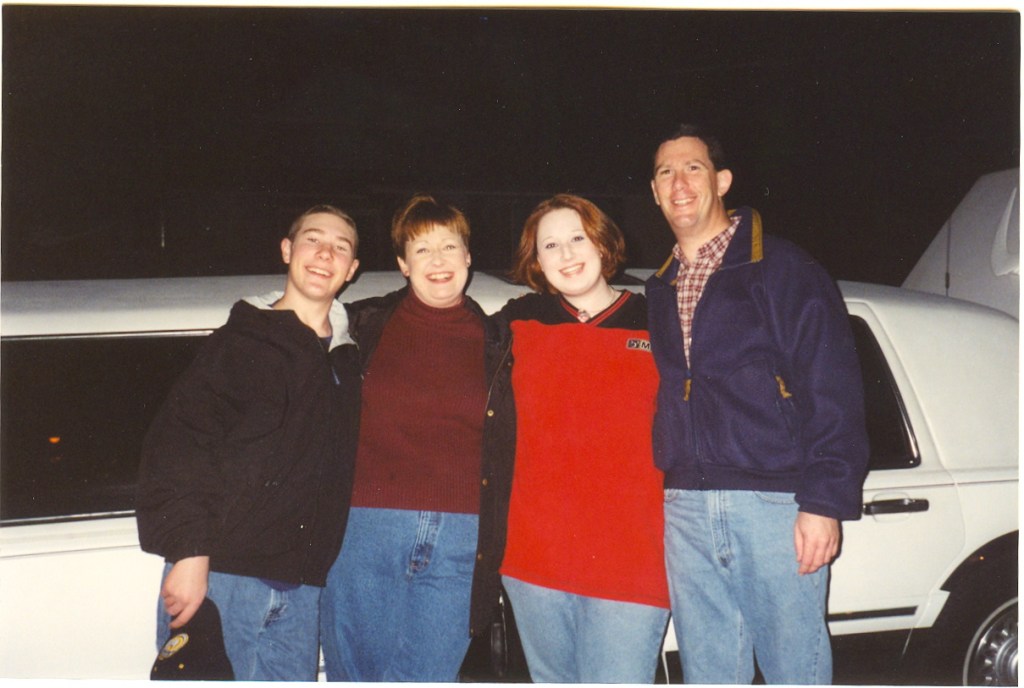 family in front of limo